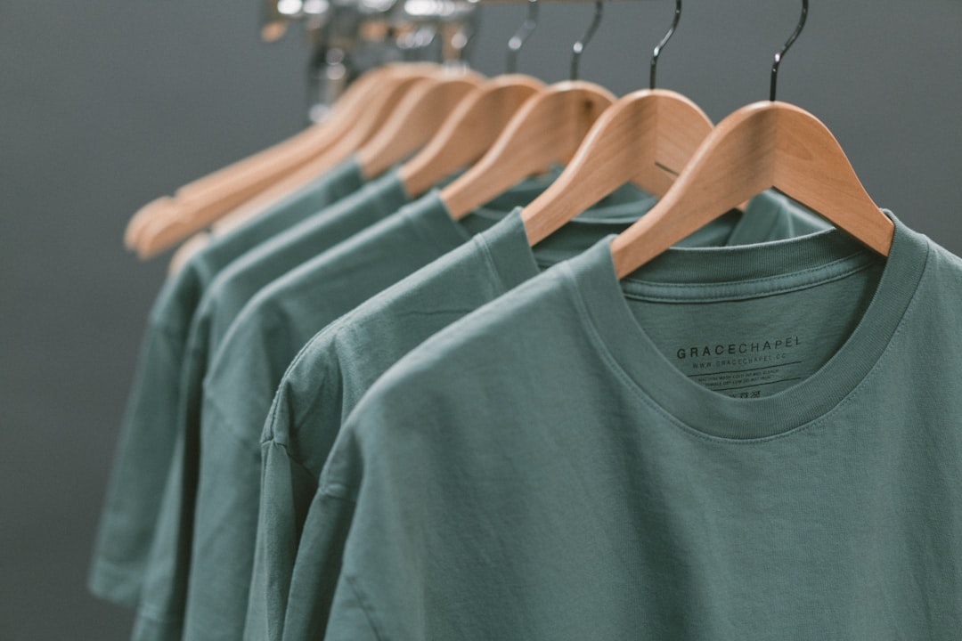 Custom t-shirts displayed on wooden hanger